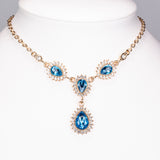 Set din Aliaj Placat cu Aur ( 32 grame ) cu Cristal Albastru Emporia® și Cristal Alb Emporia® ( Colier+Cercei+Brățară )
